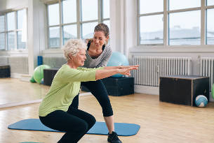 Senior Woman Working Out with Her Trainer