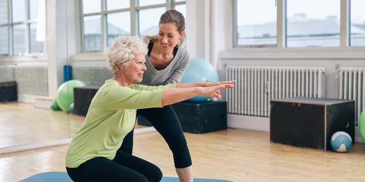 Senior Woman Working Out with Her Trainer