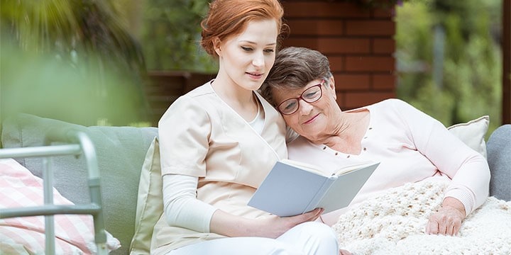 Caregiver reading to senior