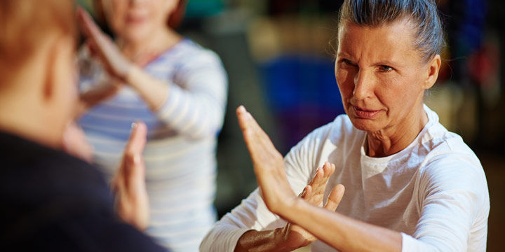 Senior woman participating in a self-defense class