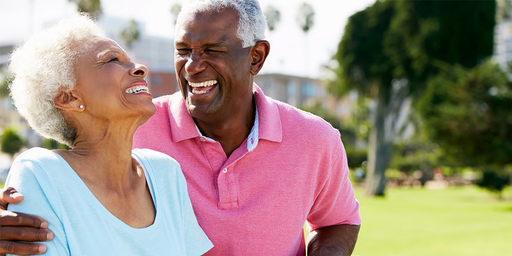 Laughing senior couple on a date in the park