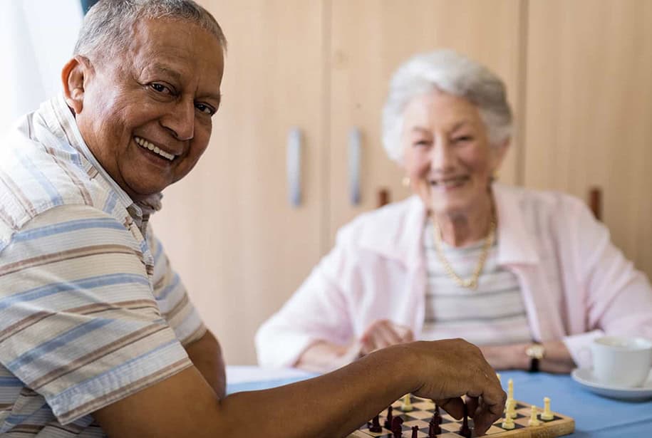 Happy seniors playing chess