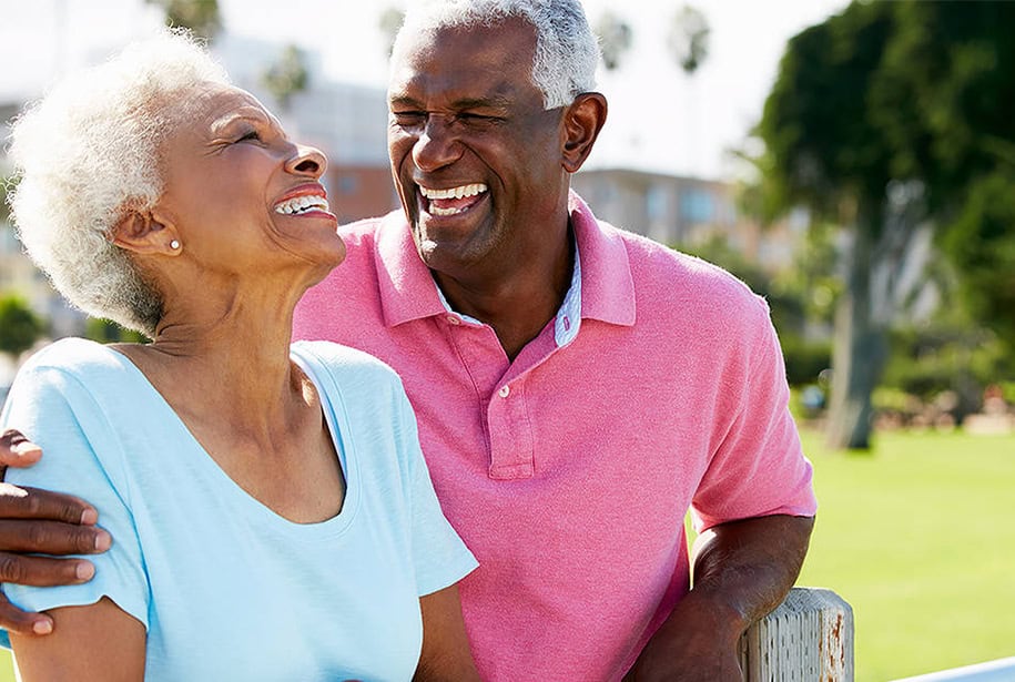 Laughing senior couple on a date in the park