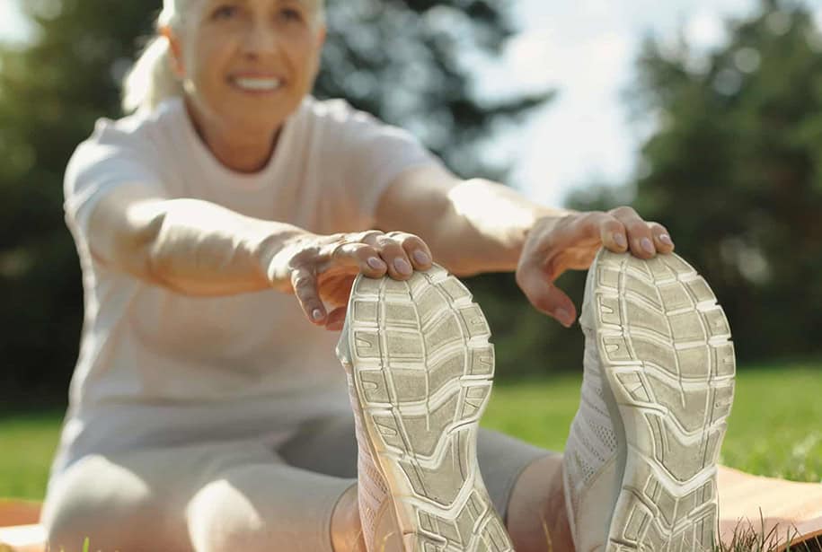 Senior stretching in running shoes