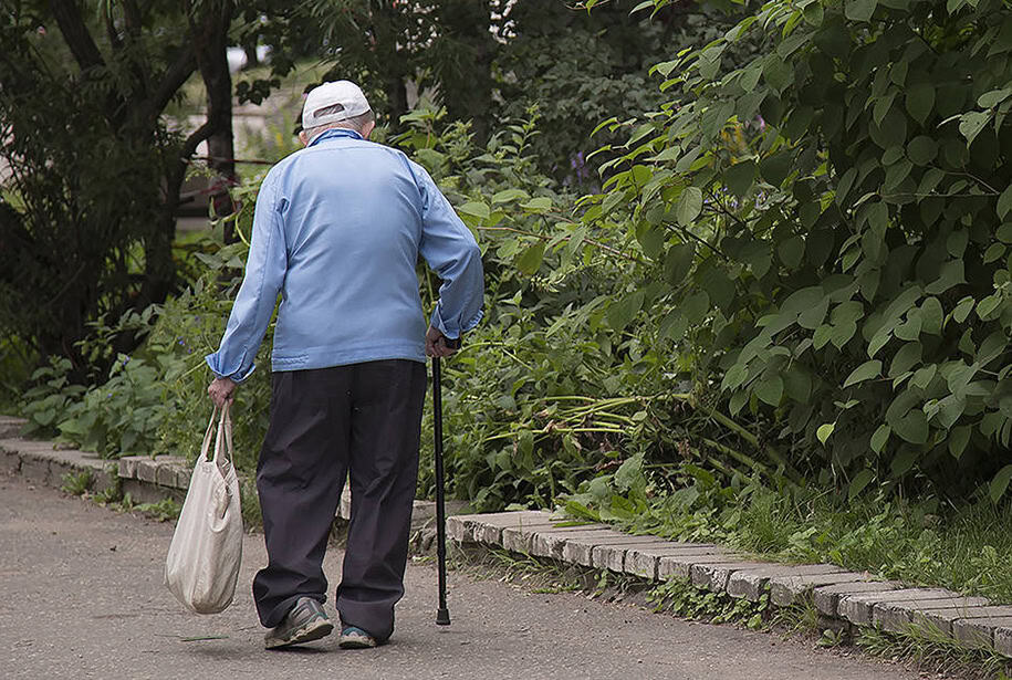 Senior gentleman walking alone in the park