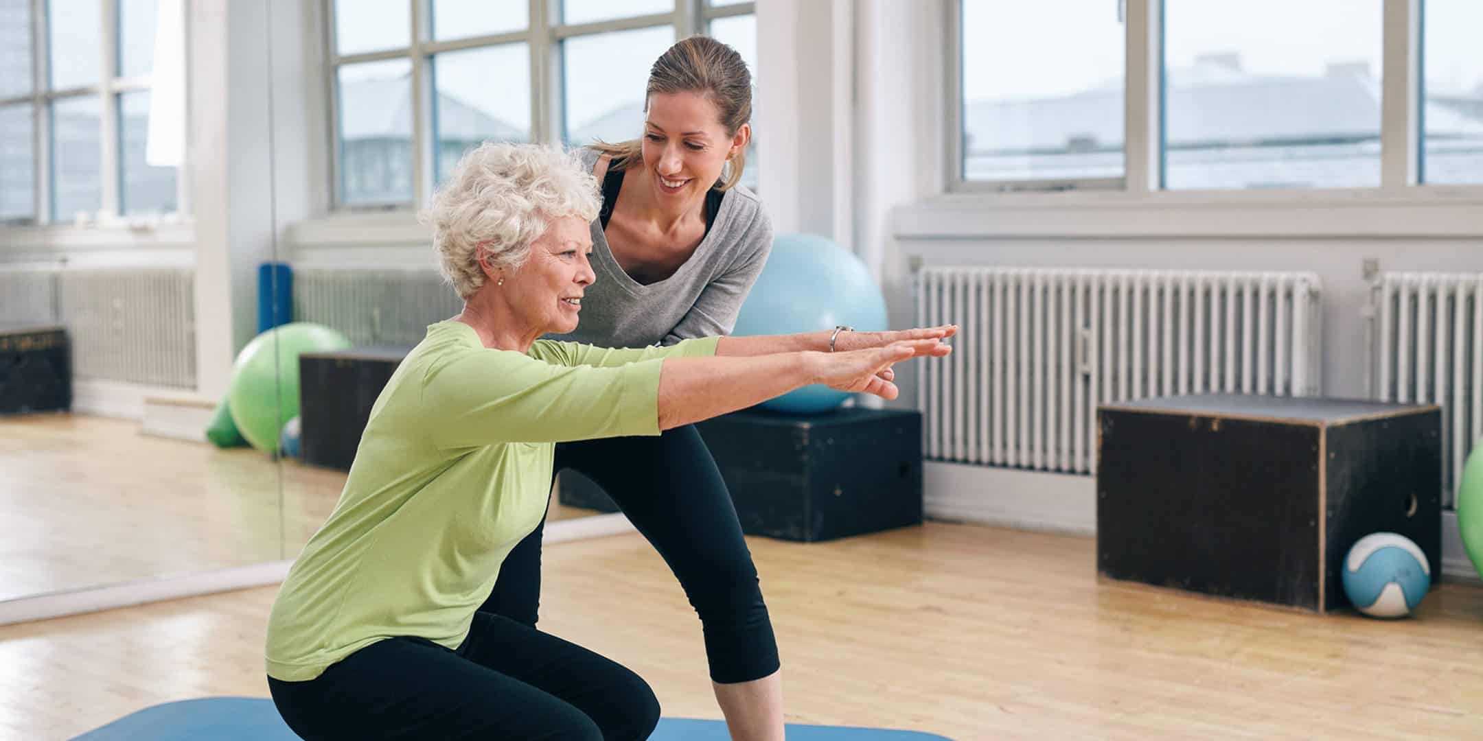 Senior Woman Working Out with Her Trainer