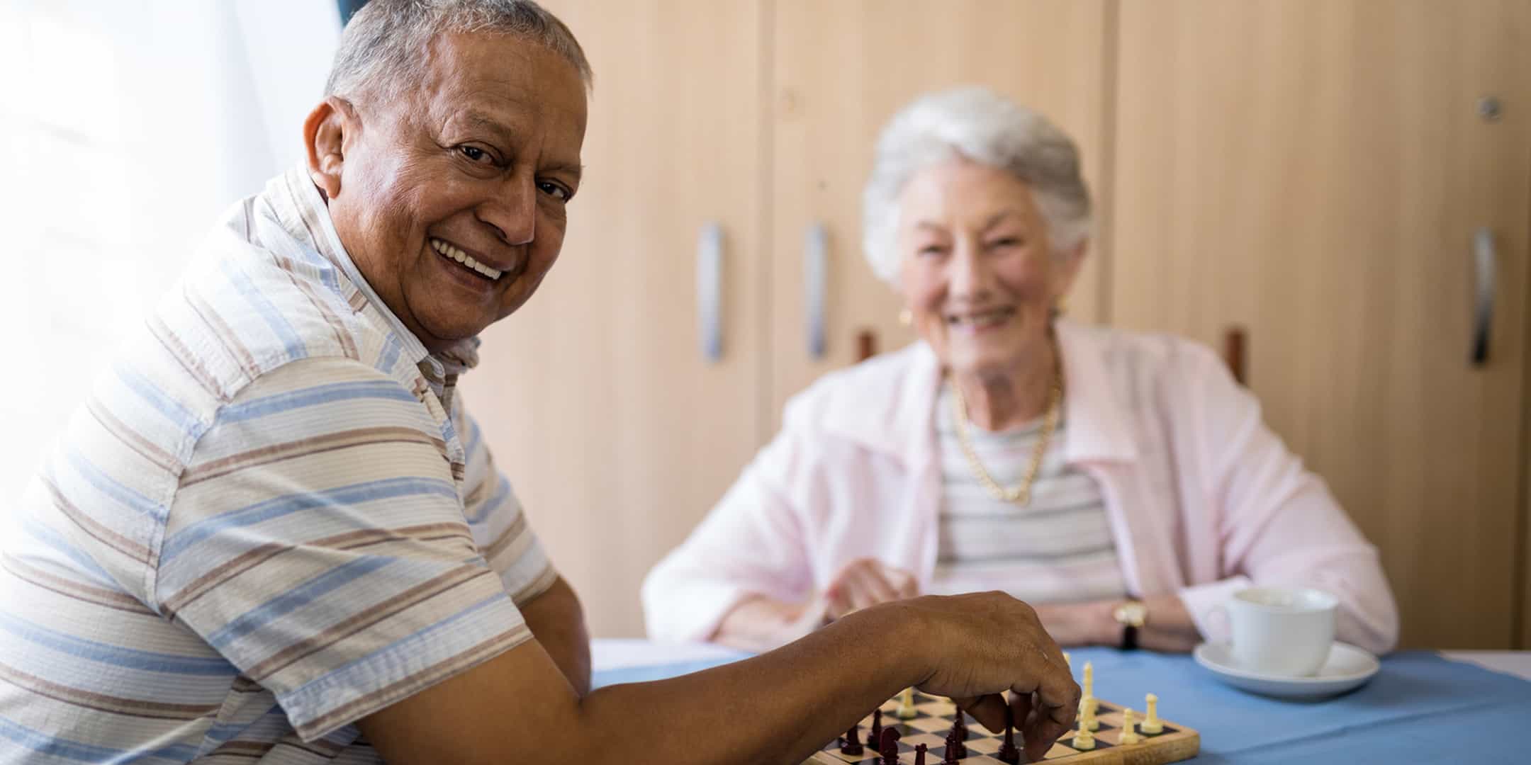 Happy seniors playing chess