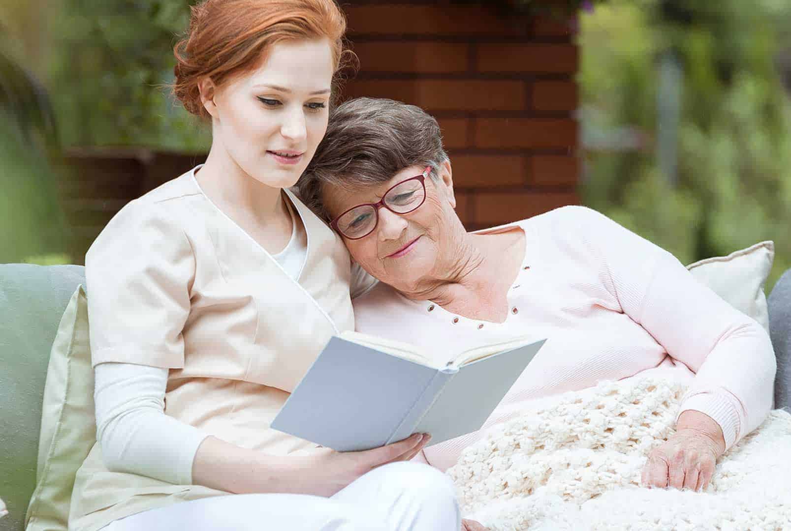 Caregiver reading to senior