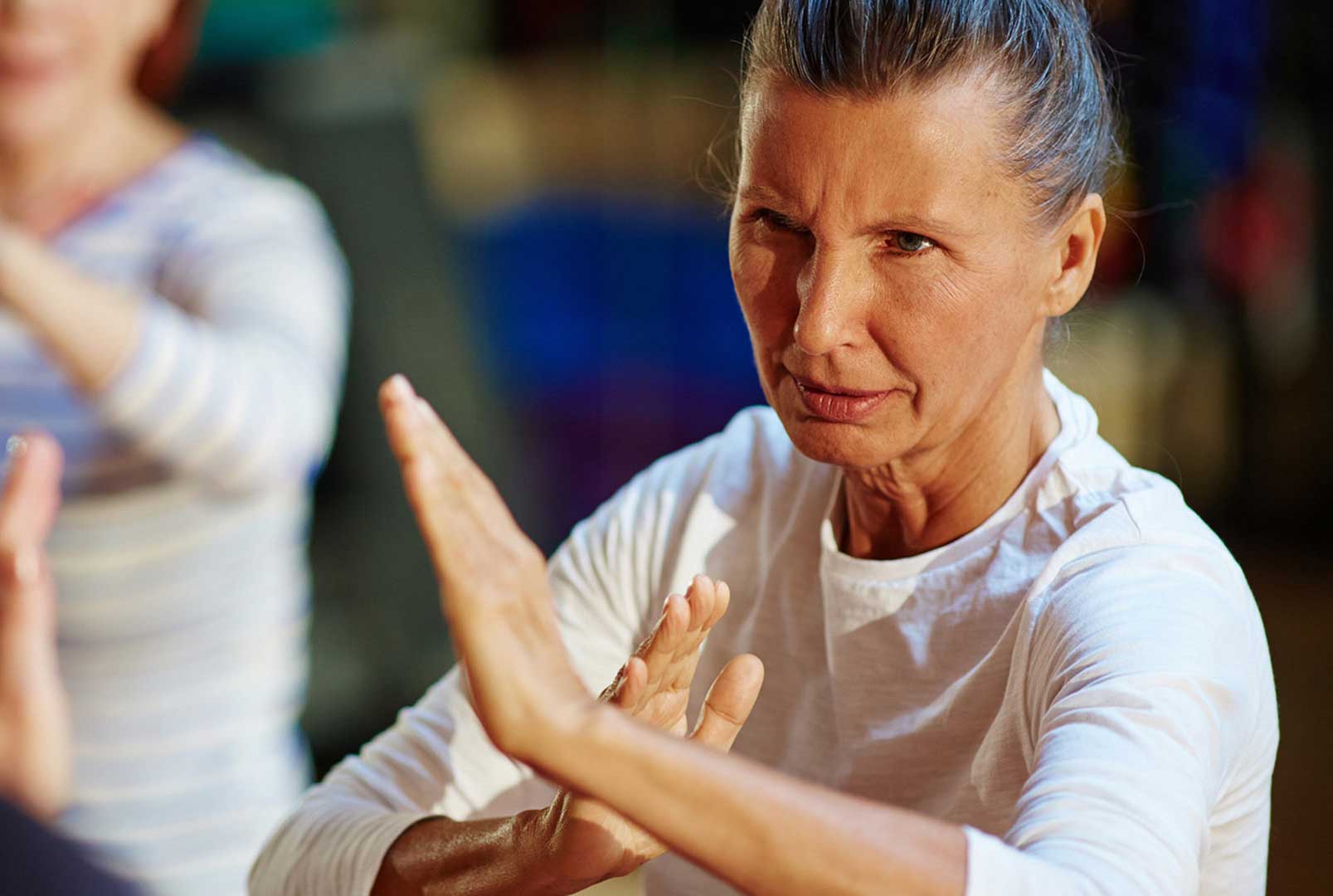 Senior woman participating in a self-defense class