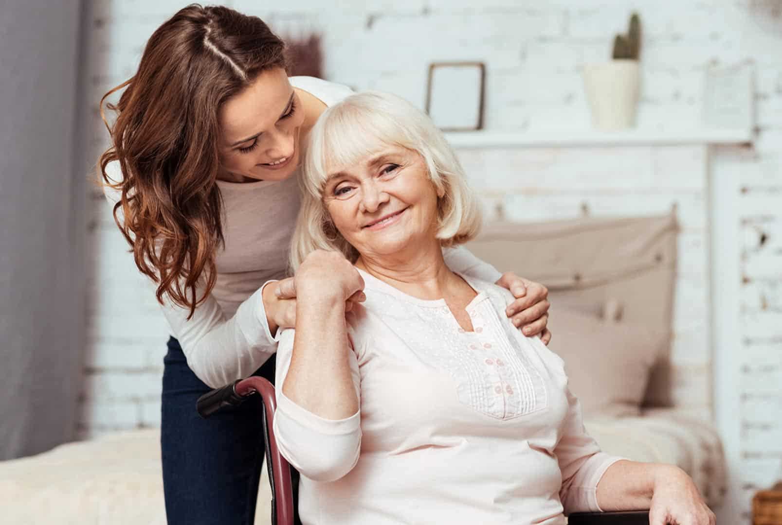 Smiling Senior Sitting Outside with his Caregiver